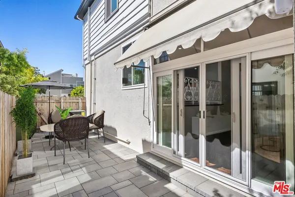 a view of a patio with a chairs and table in a patio