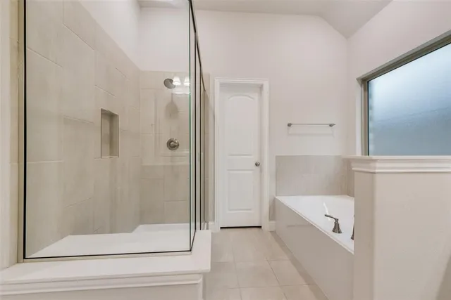 a spacious en suite bathroom with double sink and a mirror