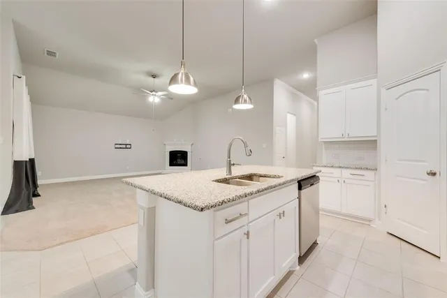 a kitchen with a stove a sink and a refrigerator