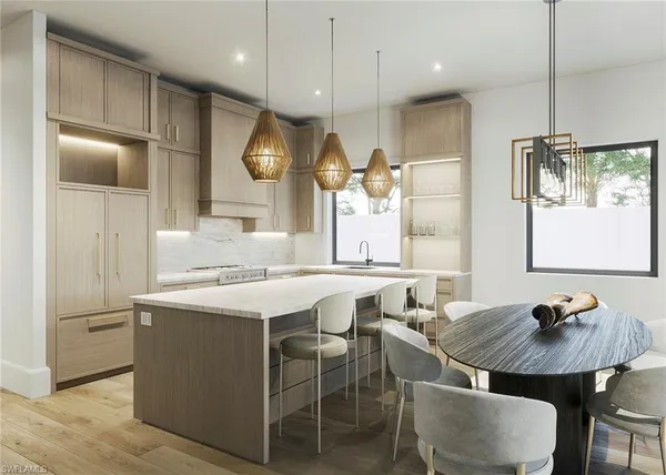 a kitchen with a table chairs refrigerator and microwave