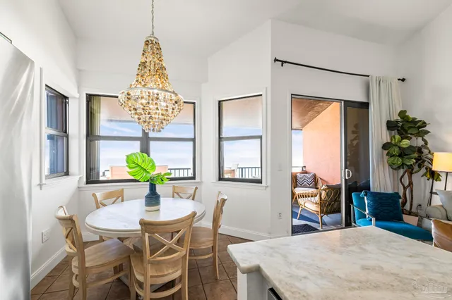 a view of a dining room with furniture and a potted plant