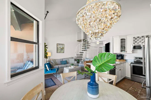 a living room with furniture a chandelier and a fireplace