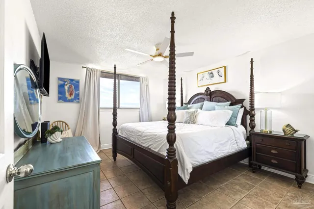 a bedroom with a bed window and dresser