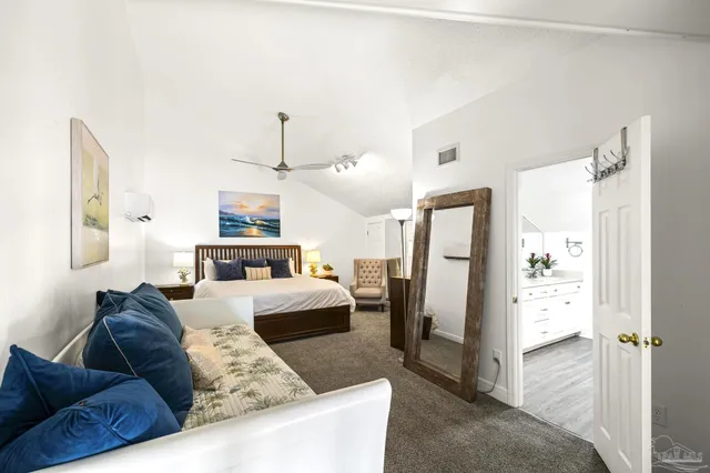 a living room with furniture and a refrigerator