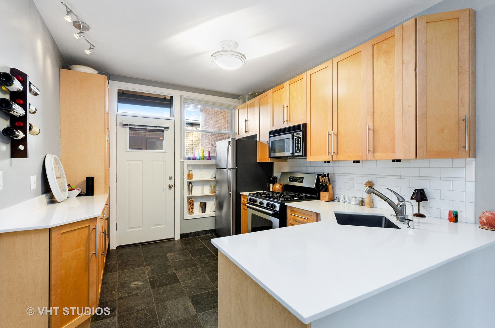 535 West Brompton Avenue, Unit 3S Chicago, IL 60657 - Photo 4 of 12 a kitchen with stainless steel appliances a stove refrigerator sink and microwave