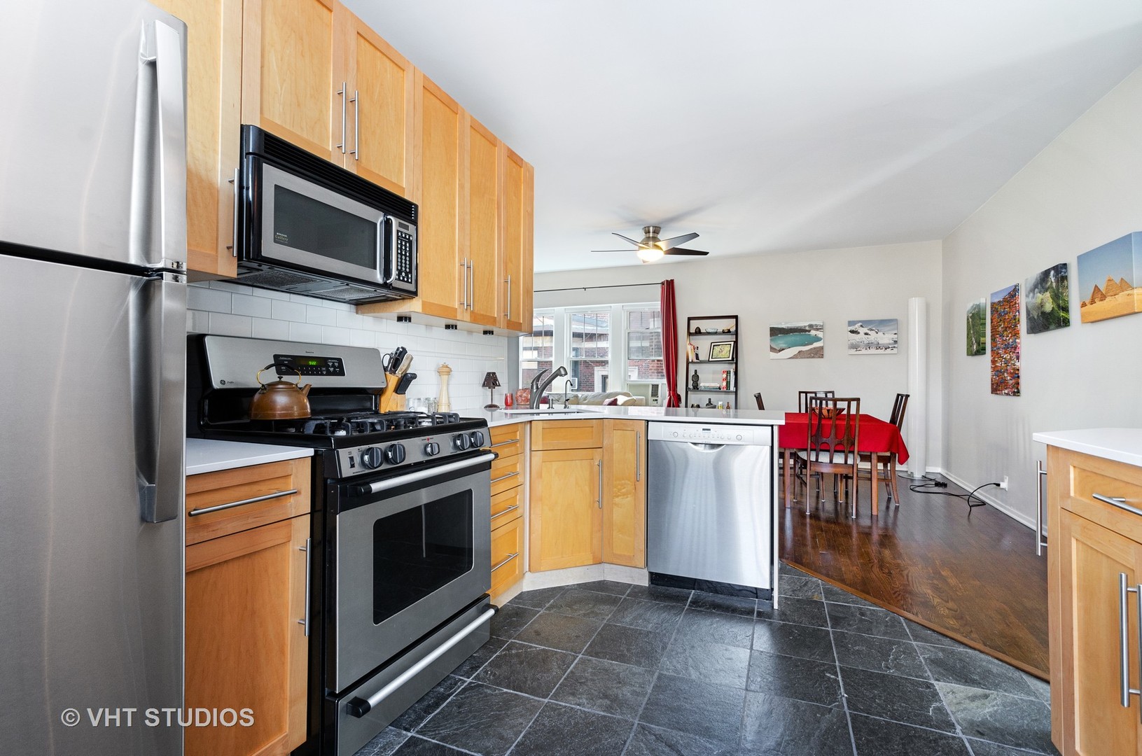 535 West Brompton Avenue, Unit 3S Chicago, IL 60657 - Photo 5 of 12 a kitchen with stainless steel appliances granite countertop a stove top oven a sink a counter space and cabinets