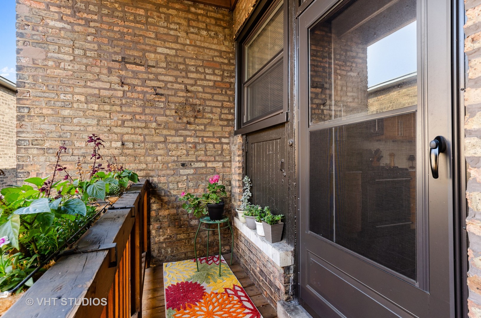 535 West Brompton Avenue, Unit 3S Chicago, IL 60657 - Photo 10 of 12 a view of balcony with wooden floor and potted plants