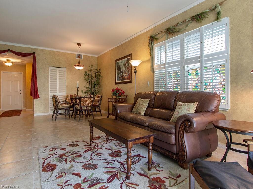 519 Roma Court, Unit 3101 Naples, FL 34110 - Photo 1 of 12 a living room with furniture and wooden floor