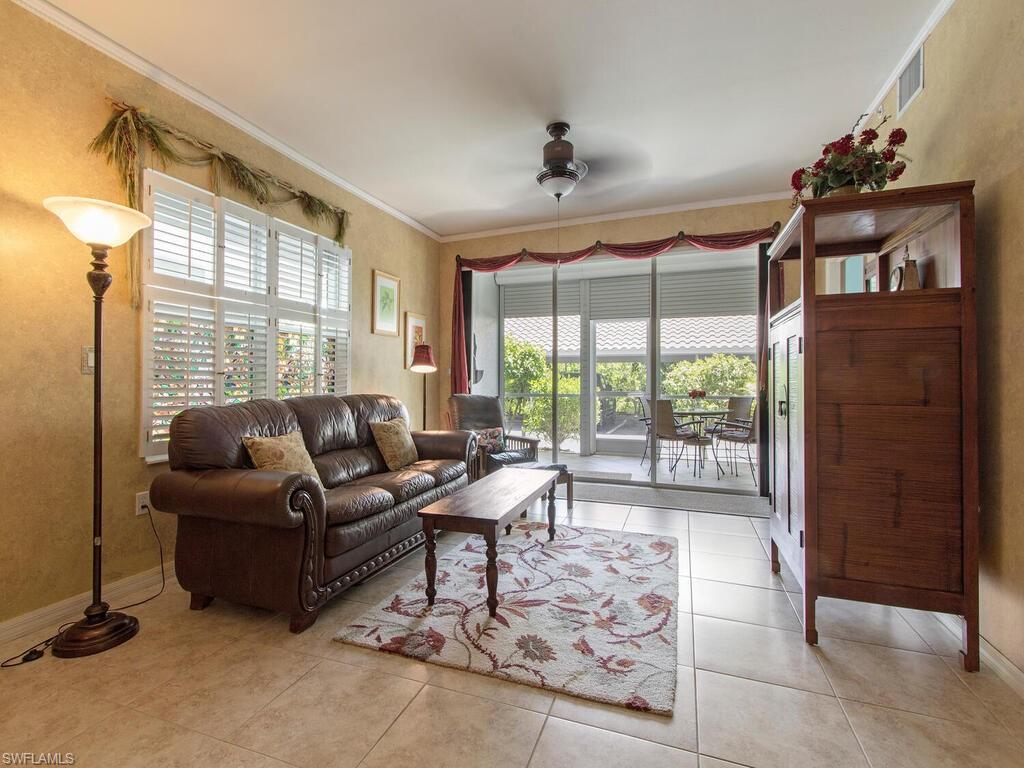 519 Roma Court, Unit 3101 Naples, FL 34110 - Photo 2 of 12 a living room with furniture and a large window