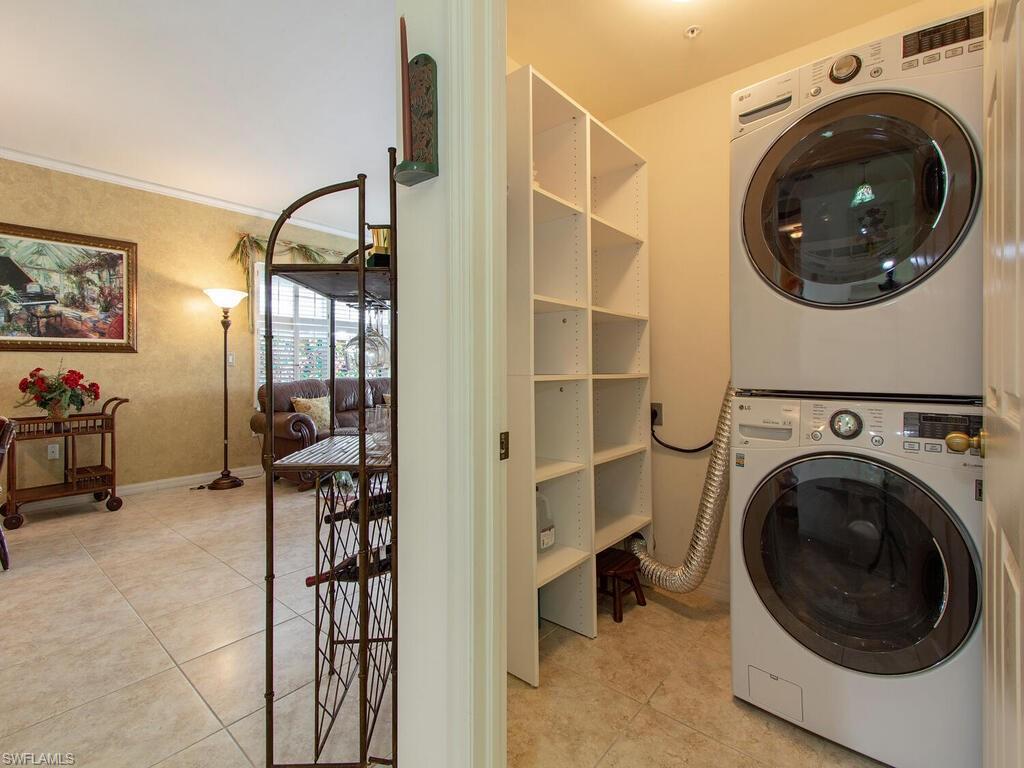 519 Roma Court, Unit 3101 Naples, FL 34110 - Photo 9 of 12 a view of a hallway with washer and dryer
