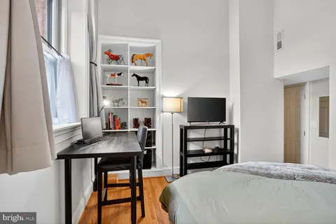 a bedroom with a bed and a flat screen tv