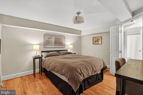 a bedroom with a bed and a night stand