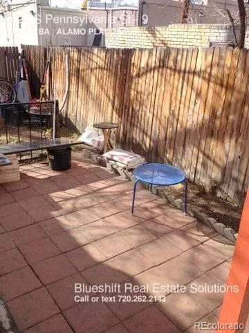 a view of a patio with a table and chairs