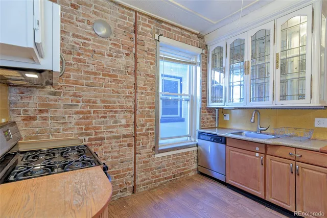 a kitchen with wooden cabinets and a stove top oven