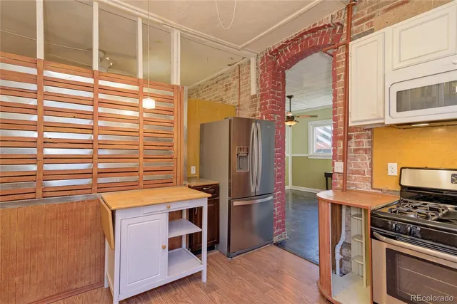 a kitchen with stainless steel appliances granite countertop a refrigerator and a stove