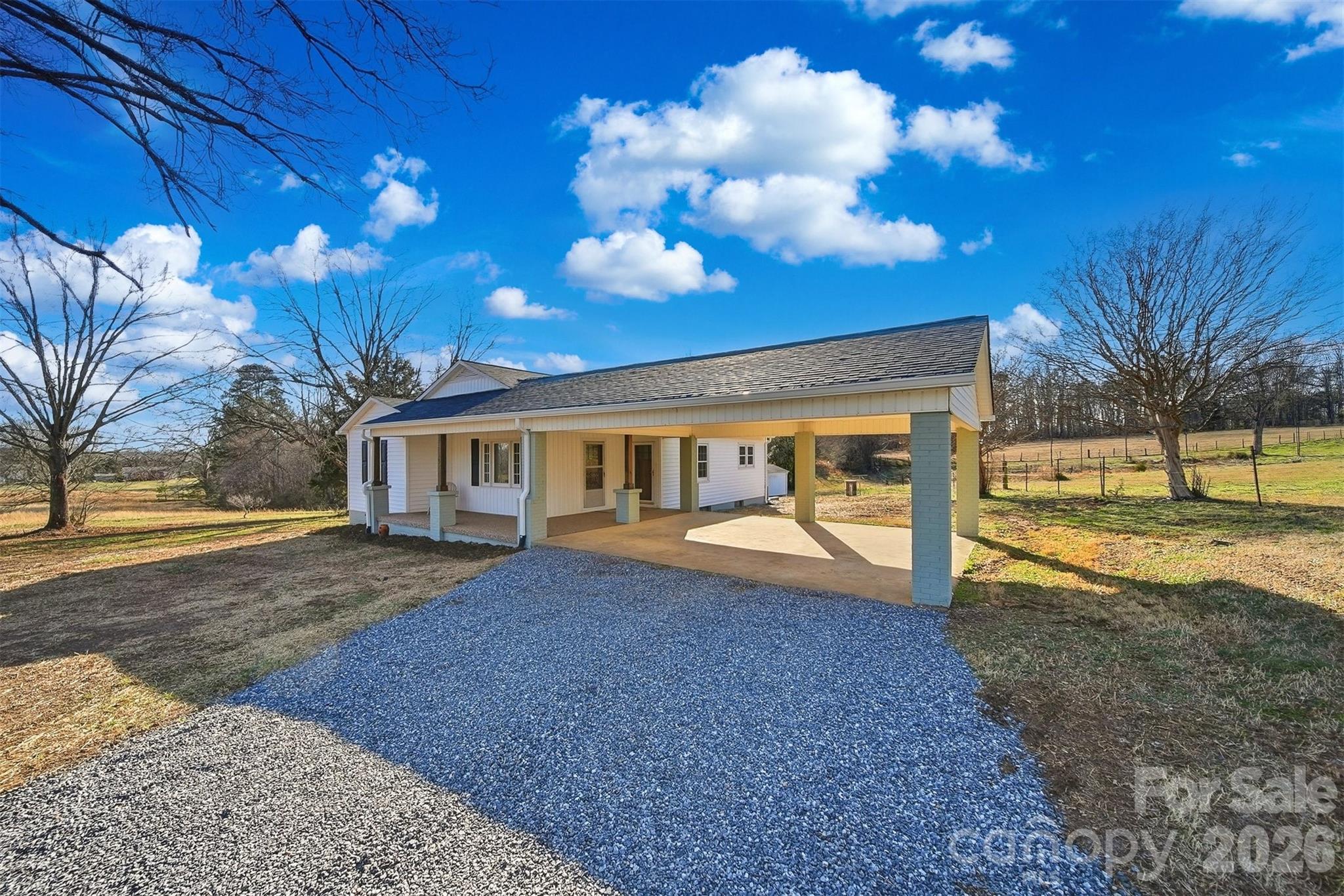 a view of a house with backyard and tree
