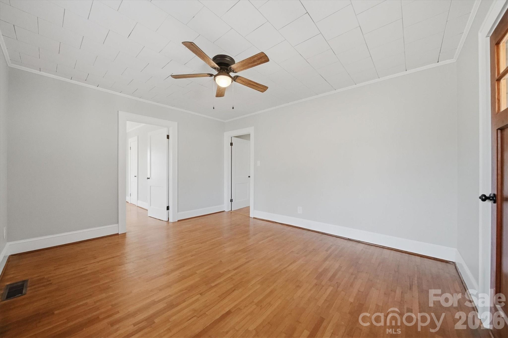 4141 Laney Road Maiden, NC 28650 - Photo 12 of 47 an empty room with wooden floor fan and windows