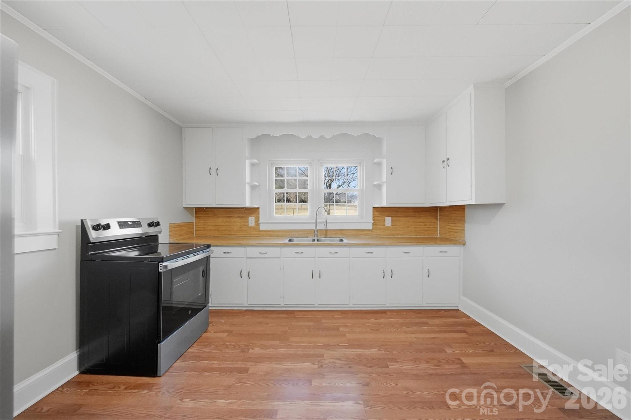 4141 Laney Road Maiden, NC 28650 - Photo 15 of 47 a kitchen with a stove top oven and white cabinets