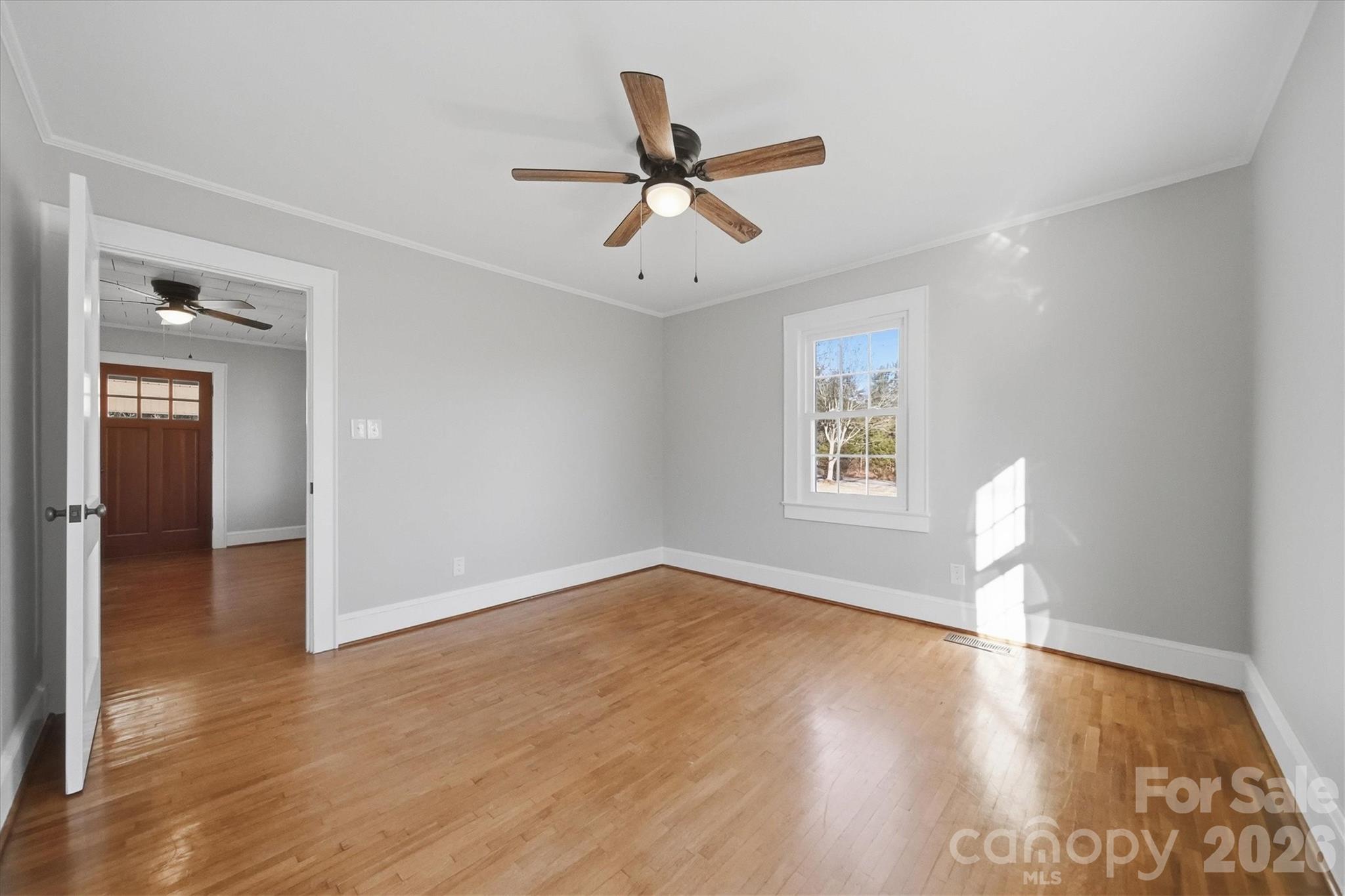 4141 Laney Road Maiden, NC 28650 - Photo 21 of 47 an empty room with wooden floor ceiling fan and windows