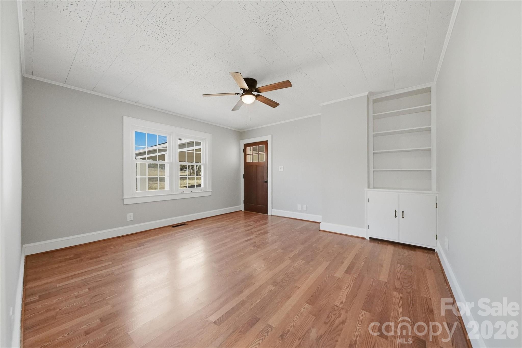 4141 Laney Road Maiden, NC 28650 - Photo 5 of 47 an empty room with wooden floor chandelier fan and windows