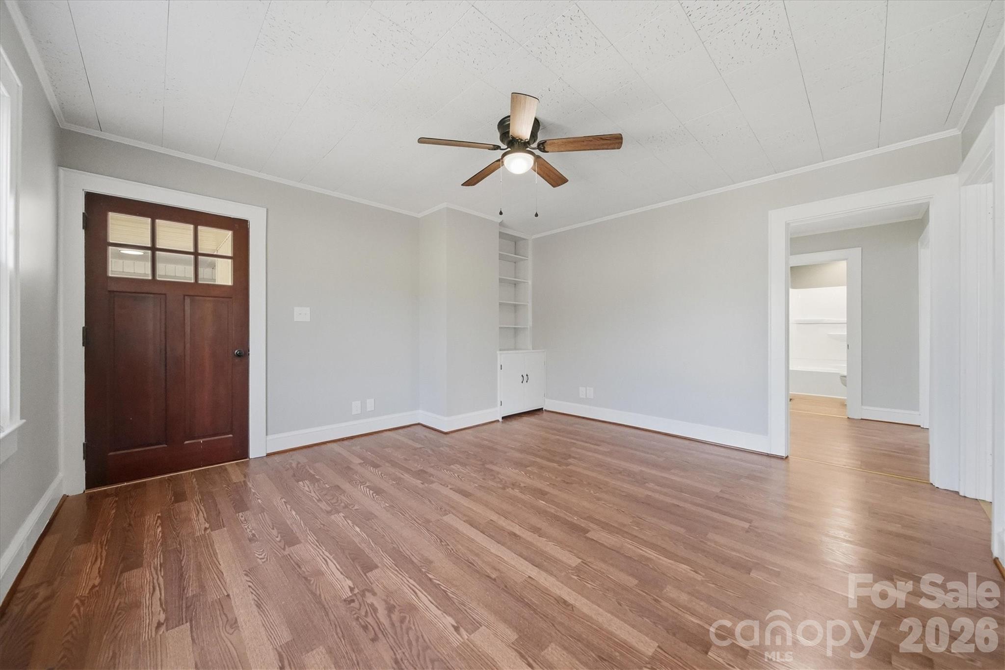 4141 Laney Road Maiden, NC 28650 - Photo 6 of 47 an empty room with wooden floor ceiling fan and windows