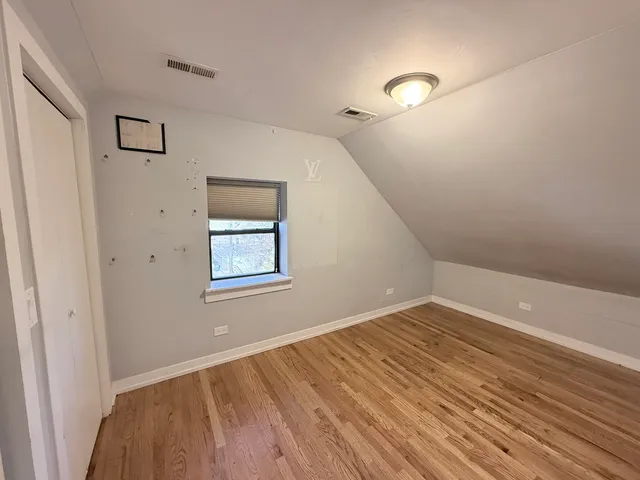 a view of a room with wooden floor and window