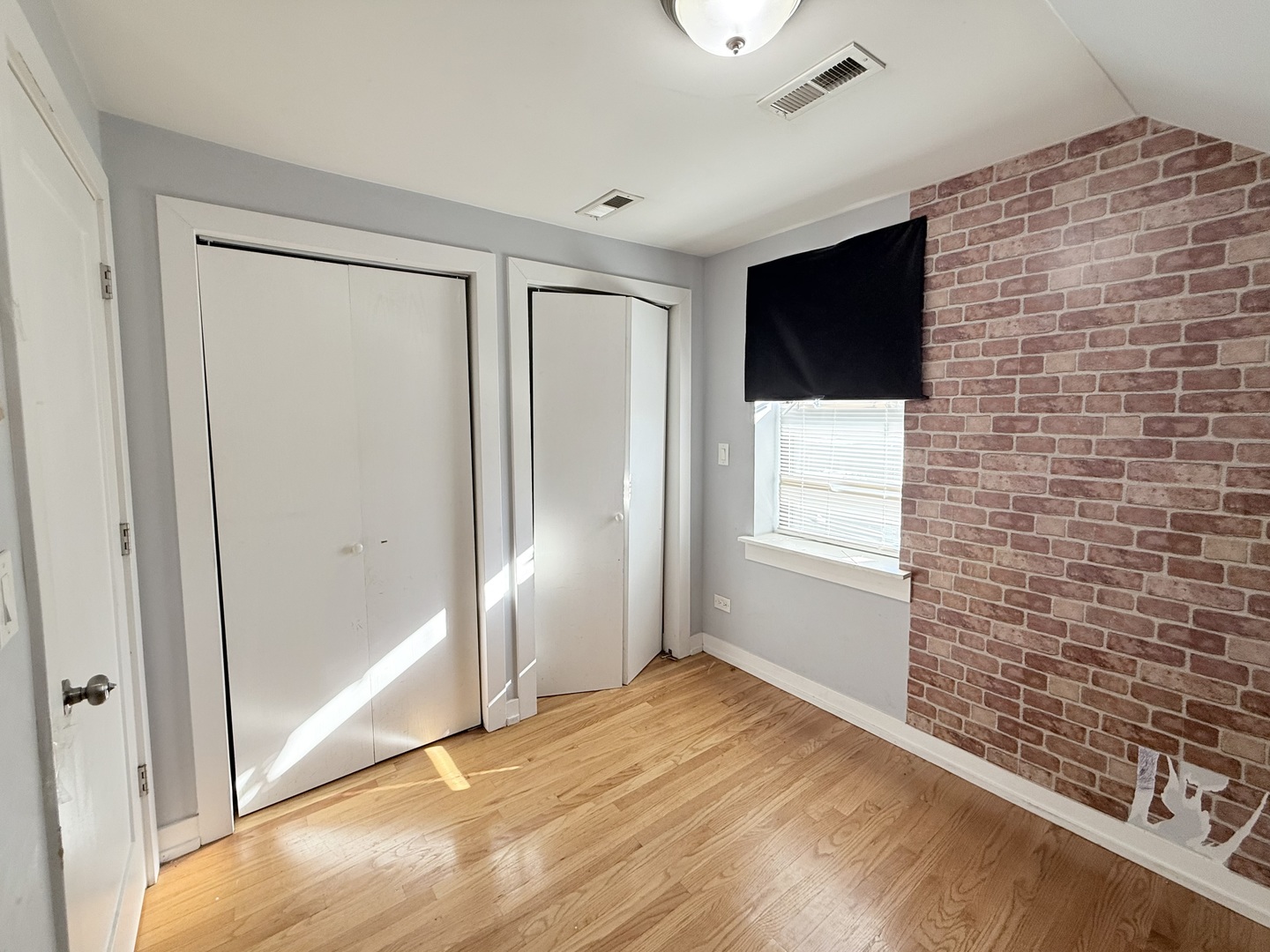 2815 West 25th Street Chicago, IL 60623 - Photo 25 of 27 a view of empty room with window and wooden floor