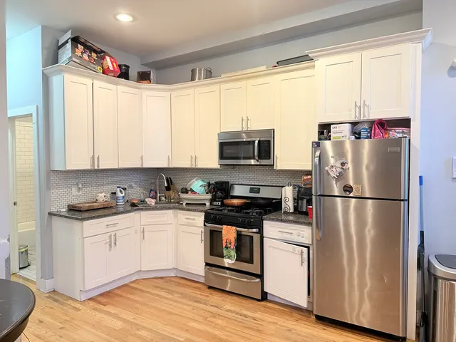 a kitchen with a refrigerator a sink and a stove