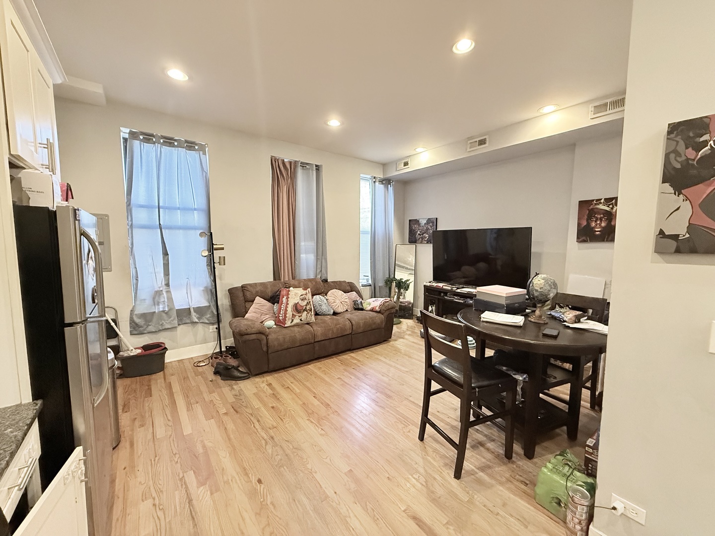 2815 West 25th Street Chicago, IL 60623 - Photo 5 of 27 a view of a workspace with furniture and a flat screen tv