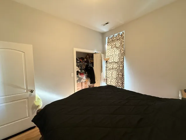 a bedroom with a bed and a window