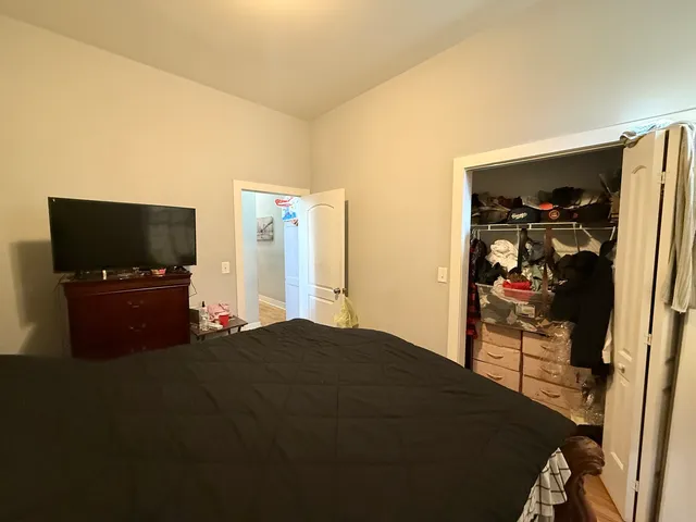 a bedroom with a bed and a flat screen tv