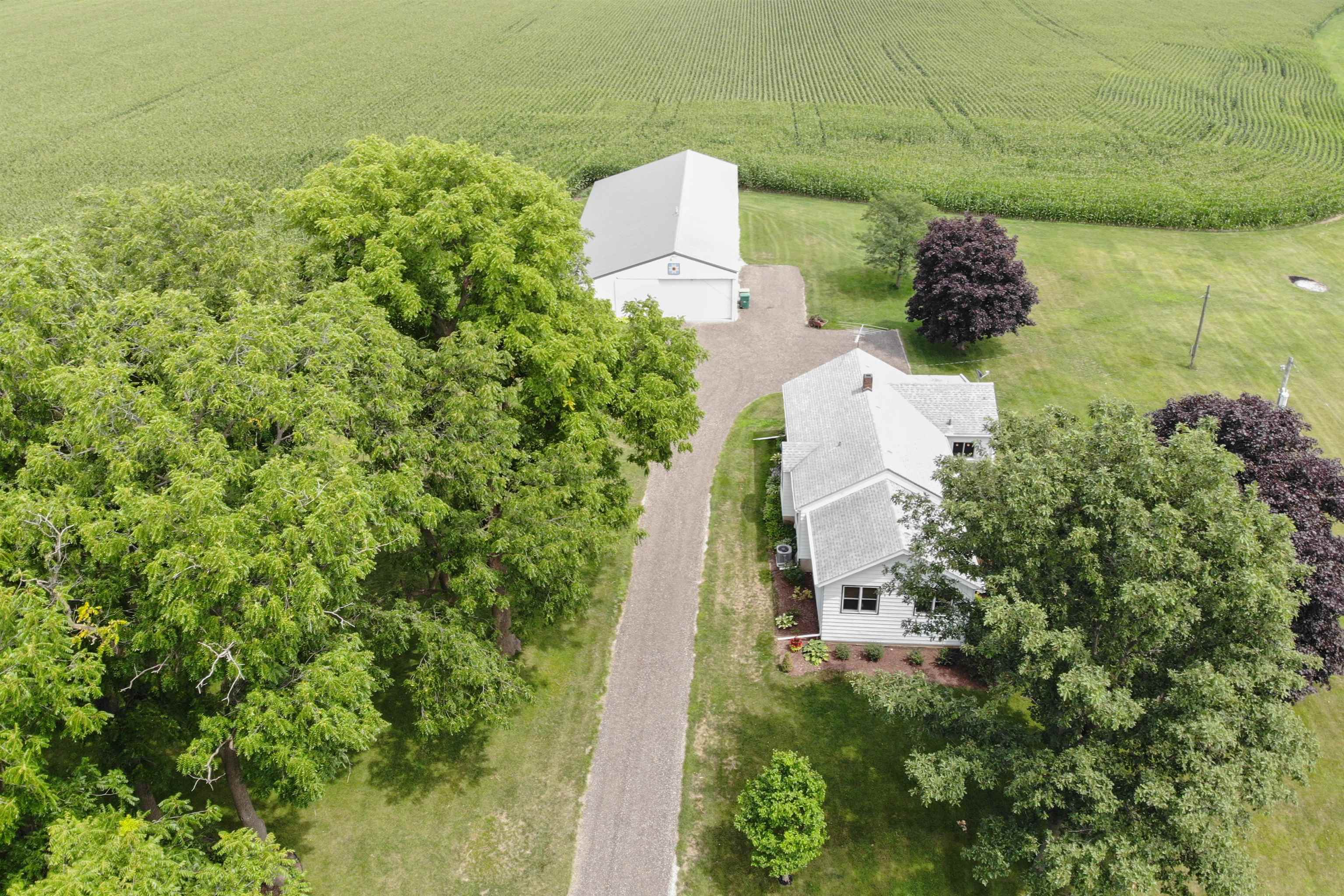 9783 North Main Road Rockton, IL 61072 - Photo 1 of 31 an aerial view of a house with a yard and garden