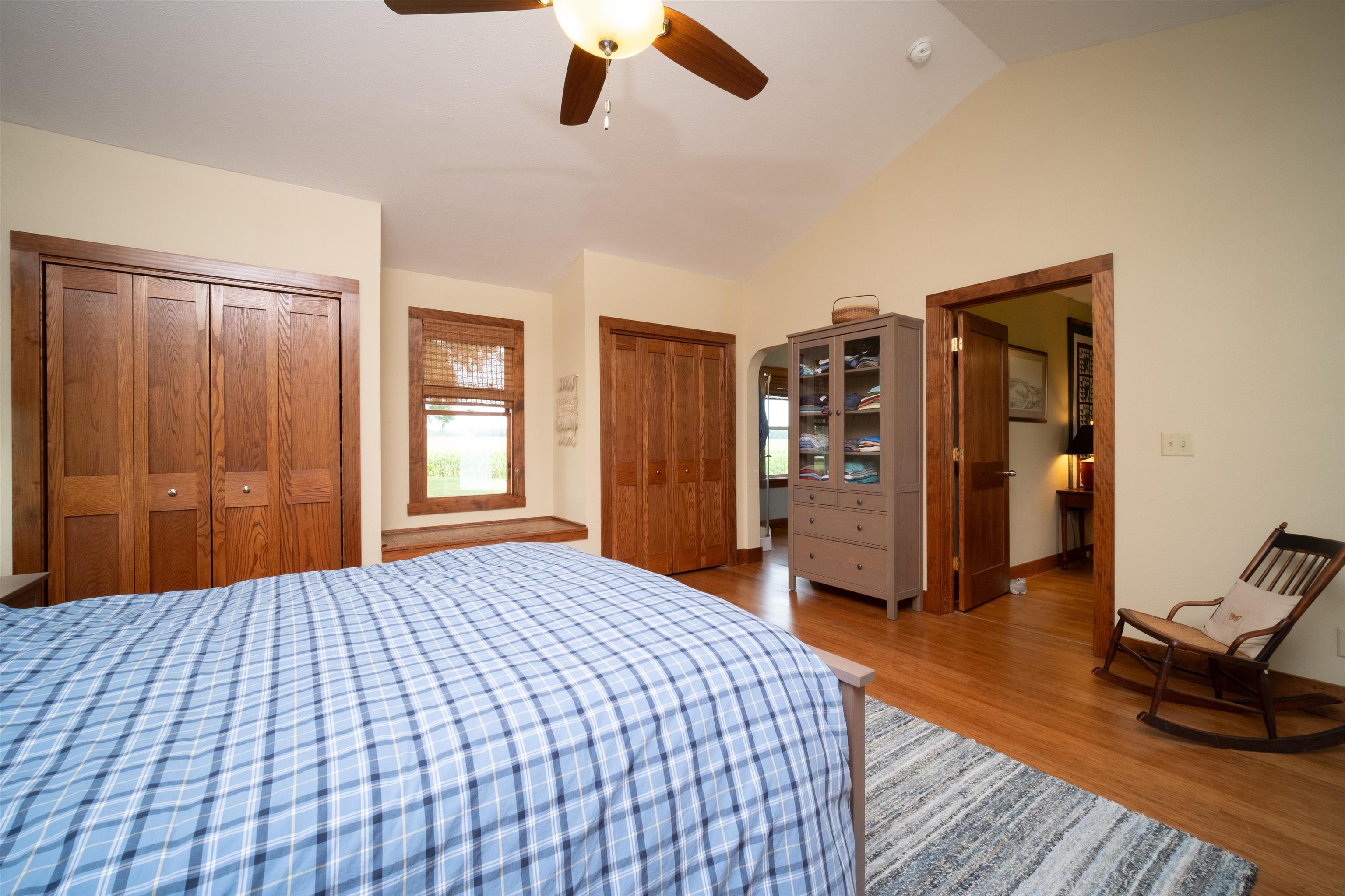 9783 North Main Road Rockton, IL 61072 - Photo 18 of 31 a bedroom with a large bed and wooden floor