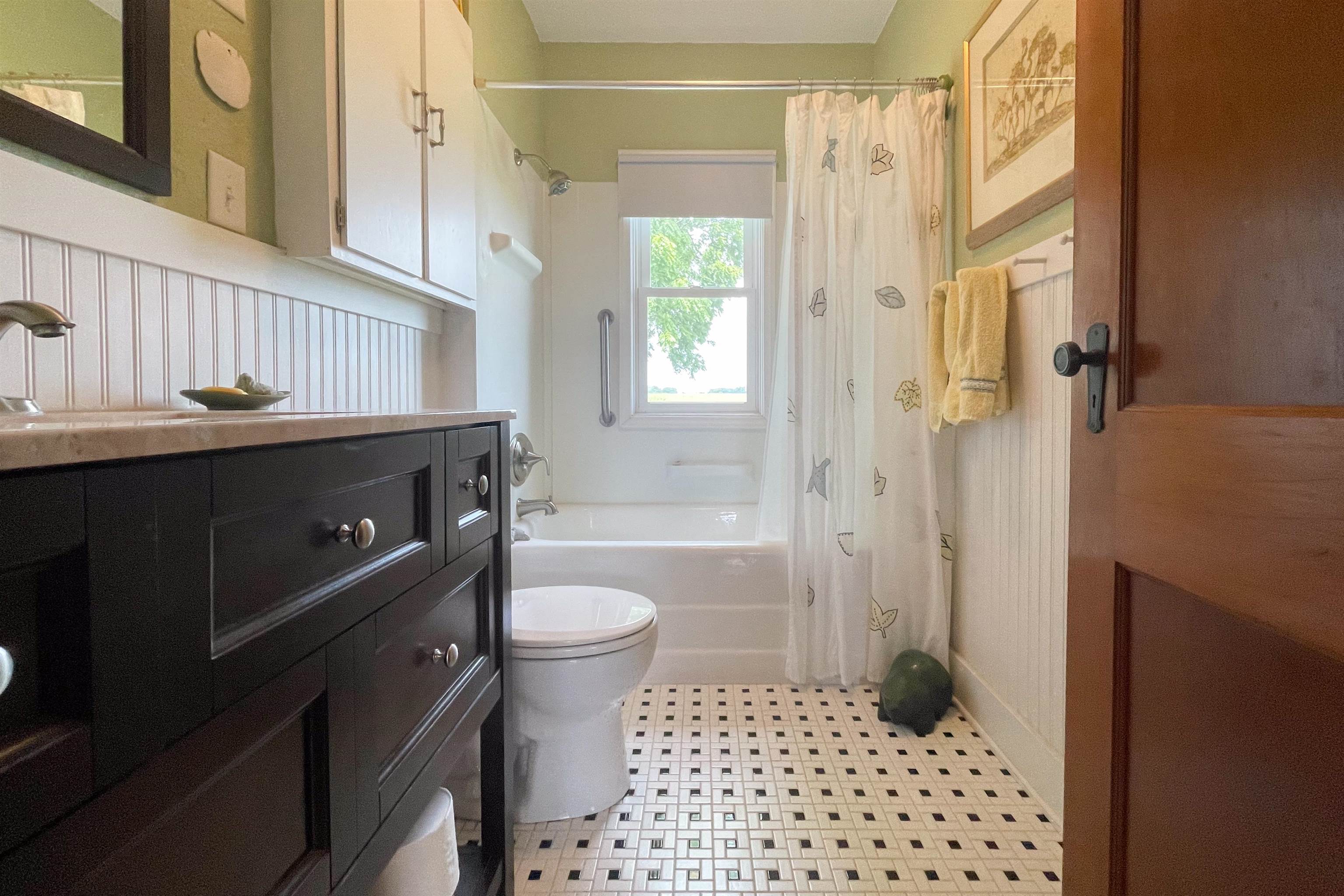9783 North Main Road Rockton, IL 61072 - Photo 23 of 31 a bathroom with a sink a toilet a window and shower