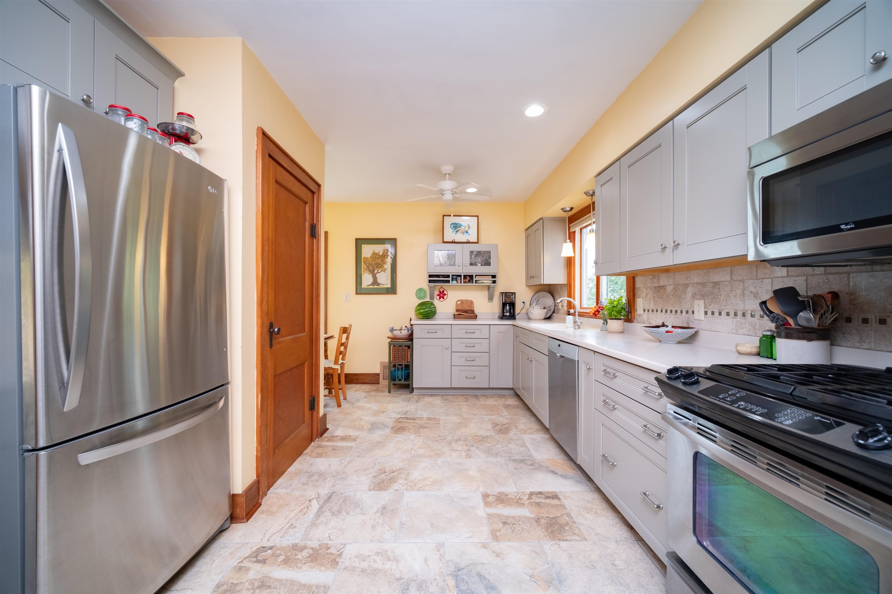9783 North Main Road Rockton, IL 61072 - Photo 9 of 31 a kitchen with stainless steel appliances granite countertop a refrigerator a stove and a sink