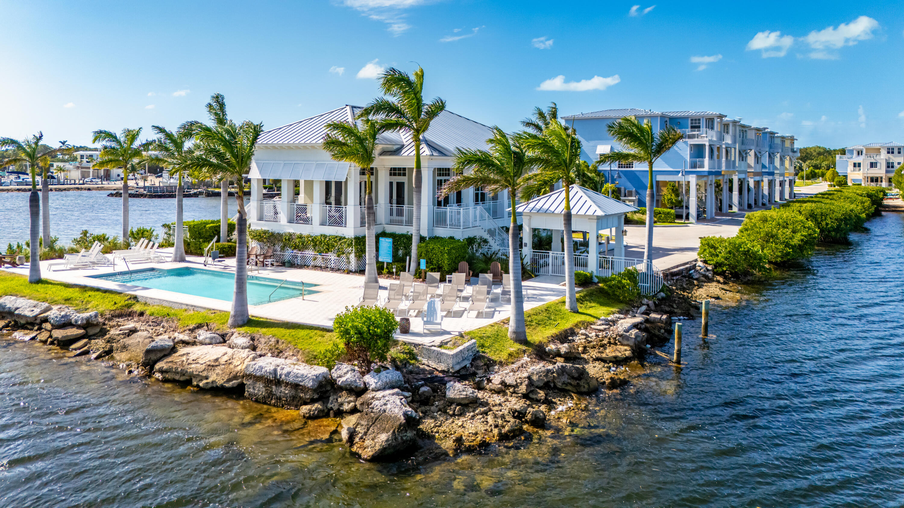 46 East Playa Largo Boulevard Key Largo, FL 33037 - Photo 27 of 48 a view of a swimming pool with lawn chairs and plants