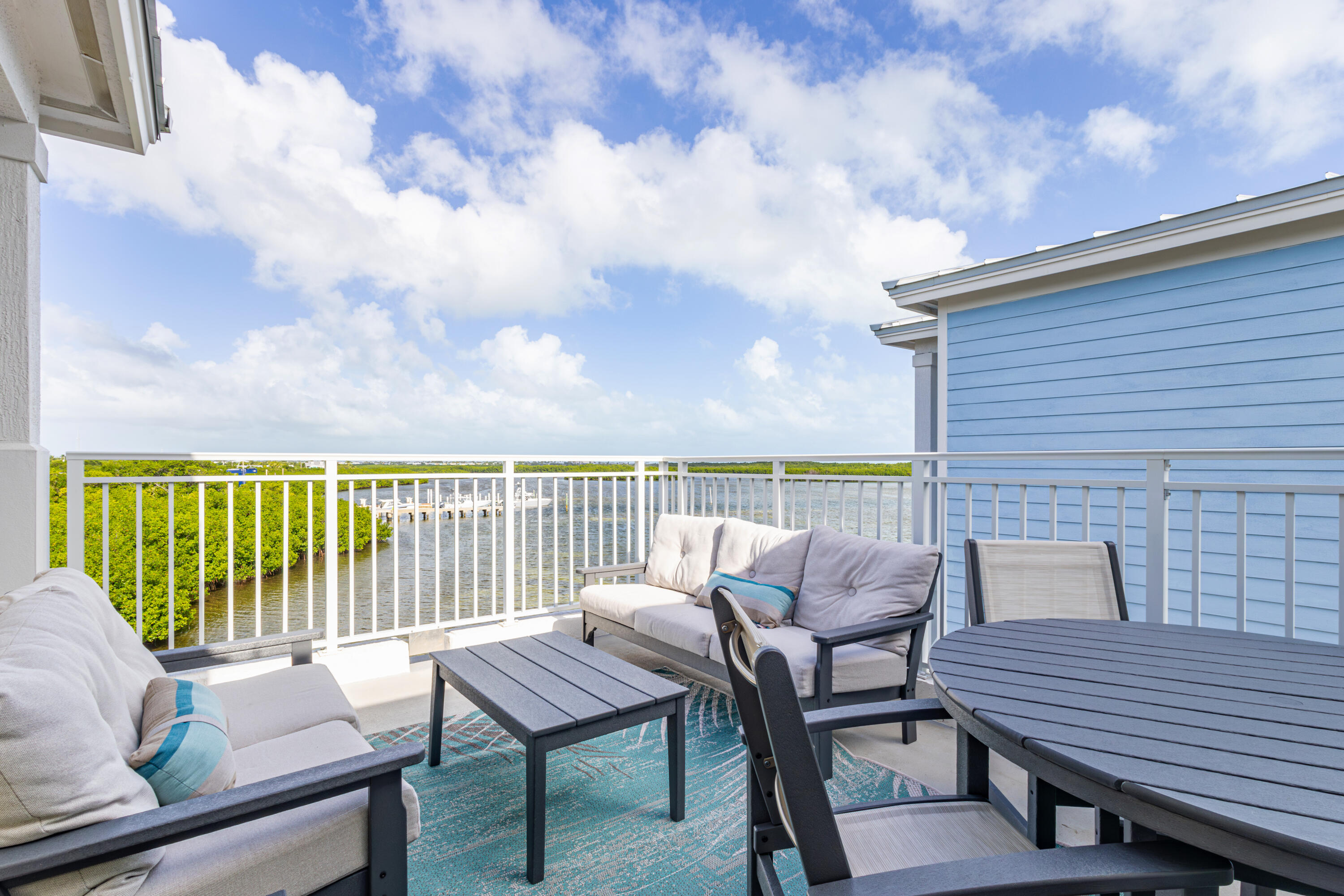 46 East Playa Largo Boulevard Key Largo, FL 33037 - Photo 4 of 48 a roof deck with a table and chairs
