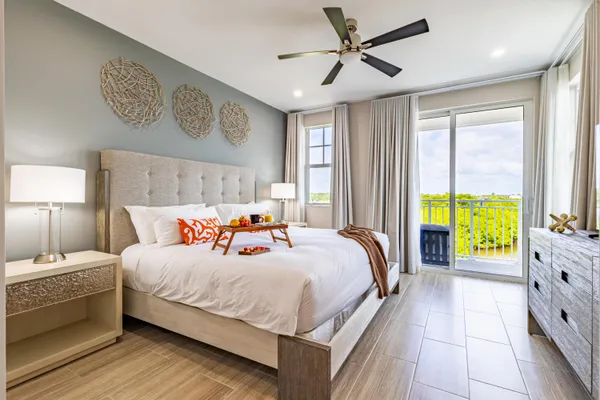 a bedroom with a large bed and a large window
