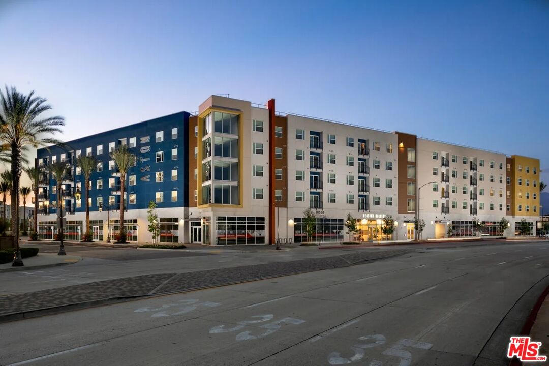 10568 Promenade Gateway, Unit 451 El Monte, CA 91731 - Photo 1 of 32 a city street lined with buildings and cars parked on the street