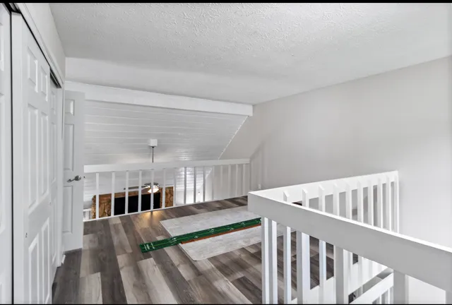 a view of entryway livingroom and hall with wooden floor
