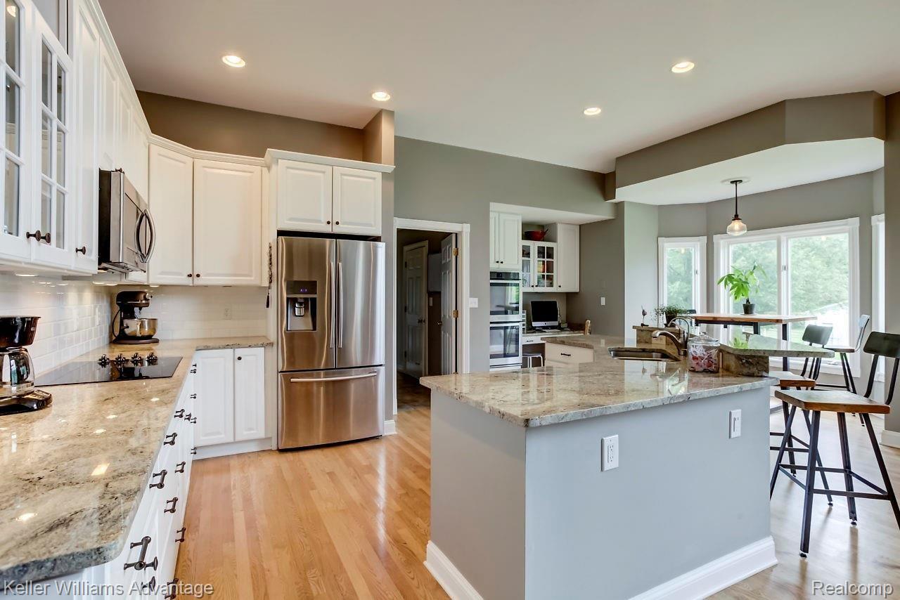 4558 Vines Road Howell, MI 48843 - Photo 8 of 46 Granite counters, Stainless Steel Appliances and plenty of recessed lighting