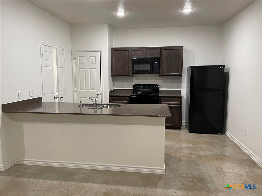 2313 Zanoletti Court Temple, TX 76504 - Photo 4 of 20 a kitchen with stainless steel appliances granite countertop a refrigerator and a stove
