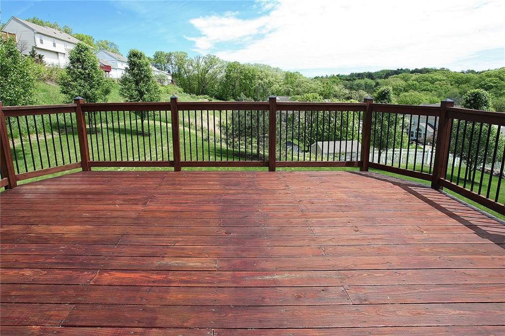 9780 Grosick Road Pittsburgh, PA 15237 - Photo 7 of 22 Walk-out onto this large 20x16 deck with iron balusters to enjoy the expansive tree-line views with ornamental pear trees and level yard for kids to play.