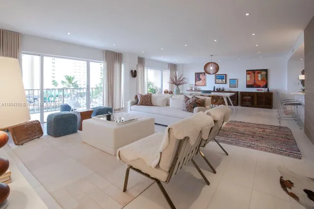 a living room with furniture and a open kitchen view