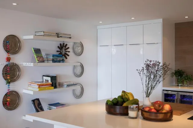 a bathroom with a sink a mirror and potted plant
