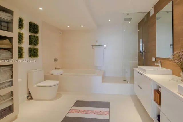 a bathroom with a double vanity sink toilet and shower