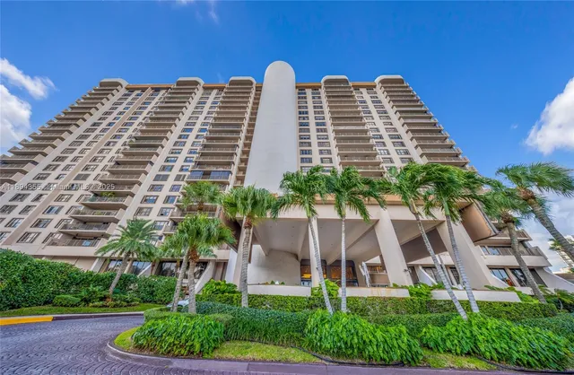 a front view of a house with a yard and a garden