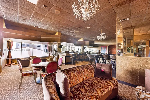 a view of living room with furniture and large windows