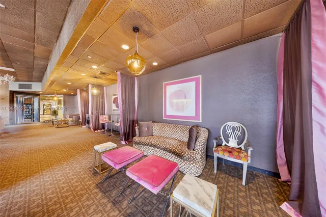 a living room with furniture a window and a chandelier