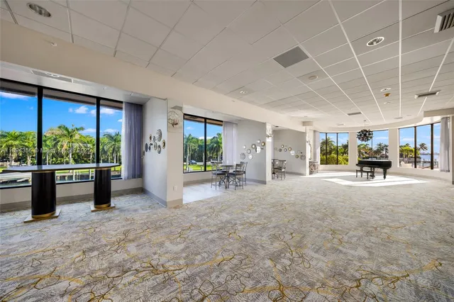 a view of a dining room with furniture large windows and wooden floor